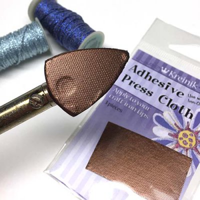 Kreinik sells adhesive press cloths that fit on craft irons