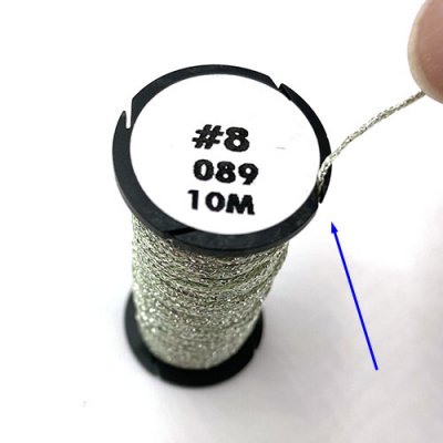 Tuck the thread end into the notch