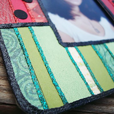 This frame was a plain wooden shape from a craft store; transformed with paper and iron on thread