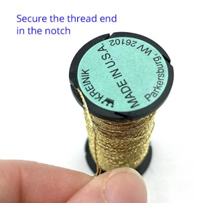Secure the thread end in a notch