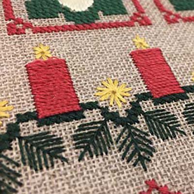 Silk Serica in long stitches make these candles in a Christmas sampler