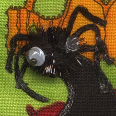 Ribbon makes spider legs on a quilt
